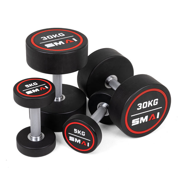Four SMAI Commercial Round CPU Dumbbells are grouped together—two pairs, one 5KG and one 30KG—with metal handles and black polyurethane heads, each featuring red and white markings on the ends.