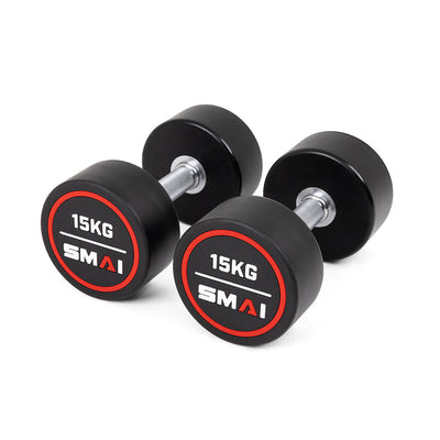 A pair of SMAI Commercial Round Dumbbells with solid, round rubber-coated weights and silver handles rests on a white background. The black dumbbells feature red and white "15KG" and "SMAI" labels—perfect for home or commercial gyms.