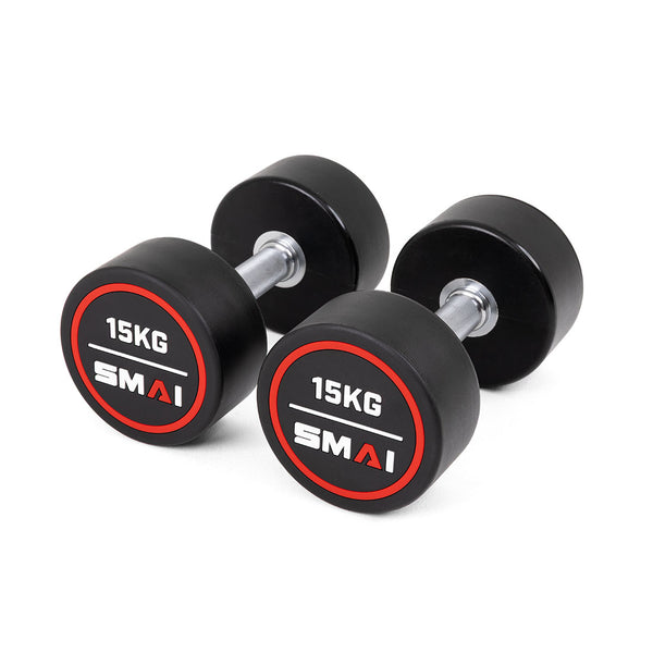 A pair of SMAI Commercial Round Dumbbells with solid, round rubber-coated weights and silver handles rests on a white background. The black dumbbells feature red and white "15KG" and "SMAI" labels—perfect for home or commercial gyms.