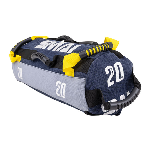 The SMAI Sand Bags - Hybrid Range features a blue and gray aramid fibre build, yellow straps, black handles, and “20 KG” print—durable gym equipment perfect for strength and endurance training.