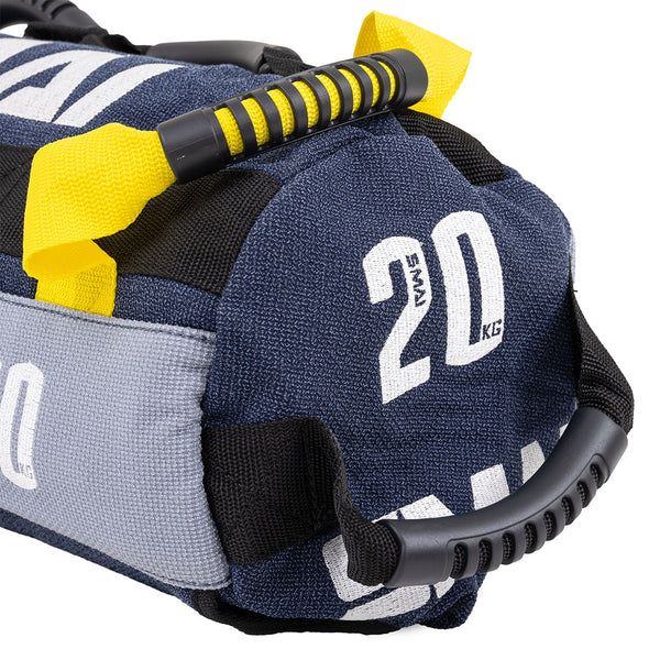 Close-up of the SMAI Sand Bags - Hybrid Range in blue and gray with "20 KG" marking, black and yellow padded handles, strong stitching, and aramid fibre—designed for strength and endurance training.