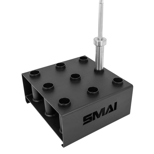 The SMAI Barbell Storage - 9 Freestanding is a black metal rack with nine vertical slots for Olympic barbells and the SMAI logo cut out on the side. One barbell is shown inserted in a slot.