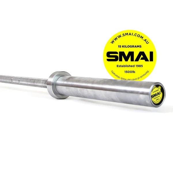 The 15kg barbell from Sale Item's 155kg HD Bumper Plate Set is perfect for Olympic lifting. It features a striking yellow circular SMAI logo, with the website www.smai.com.au and the text "established 1985." Designed to support up to 1500 pounds, this silver barbell ensures quality and durability for any home lifting setup.