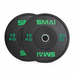 A pair of SMAI Home Gym Bumper Plates - 10kg, featuring the SMAI brand and "10 KG" in green text, are stacked with partial overlap on a white background.