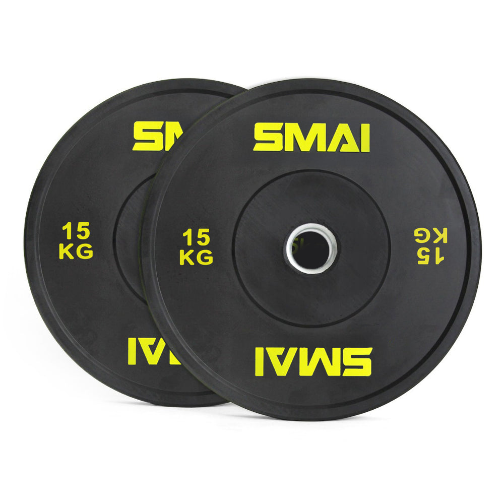 A pair of SMAI Home Gym Bumper Plates - 15kg each, in black with yellow SMAI logo and metal center ring, ideal for home gyms. Plates are shown slightly overlapping.