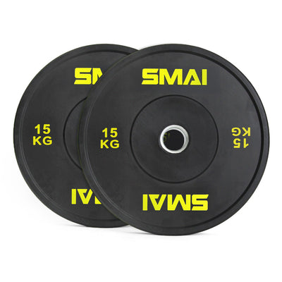 A pair of SMAI Home Gym Bumper Plates - 15kg each, in black with yellow SMAI logo and metal center ring, ideal for home gyms. Plates are shown slightly overlapping.