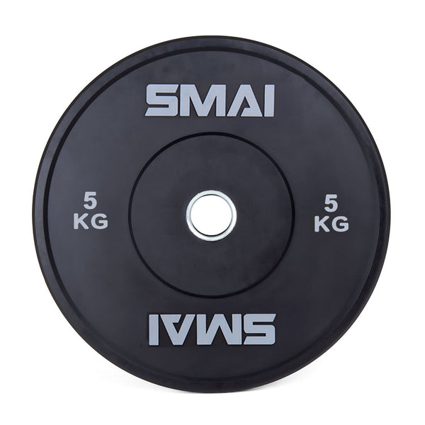 The SMAI Home Gym Bumper Plates - 5kg (Pair) feature a black design with "SMAI" and "5 KG" in white on both sides and a silver metal ring, making them perfect as Olympic or home gym bumper plates.