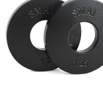 Two SMAI Fractional Plate Pair 1.25kg in black, stand upright against a white background. Designed for micro-loading, these plates feature circular centers for easy integration with a barbell.
