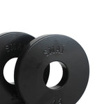 A pair of black "SMAI" embossed fractional plates, ideal for micro-loading, each featuring a central hole for a barbell. The visible plate displays "2.5kg," showcasing its weight. The clean, white background accentuates their sleek design, making them perfect for precision in weight training.