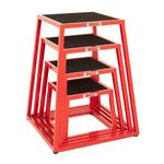 The SMAI Steel Plyo Box Set - 4 Pack Stackable includes four red metal boxes of different heights, each with a black non-slip top and SMAI branding on the front, ideal for commercial plyometric training.