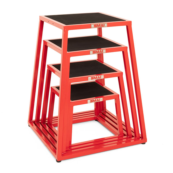 The SMAI Steel Plyo Box Set - 4 Pack Stackable includes four red metal boxes of different heights, each with a black non-slip top and SMAI branding on the front, ideal for commercial plyometric training.