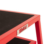 Close-up of a red SMAI Steel Plyo Box from the 4 Pack Stackable Set, featuring a black non-slip surface and metal "SMAI" label.