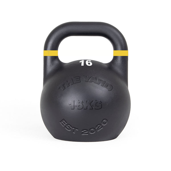 The SMAI The Yard - Competition Steel Kettlebell 16kg is black with a yellow stripe, labeled "16" and "16KG," and features "THE YARD" and "EST 2020" on the front. Consistent size design supports uniform training.