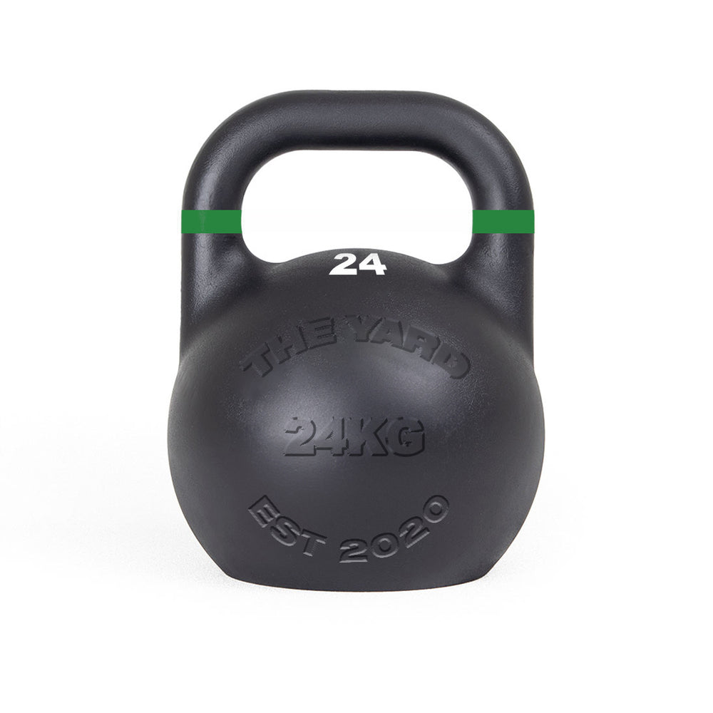 The SMAI The Yard - Competition Steel Kettlebell 24kg is black with a green stripe near the handle, "24" on top, and "THE YARD 24KG EST 2020" embossed on the front, ensuring consistent size and custom branding for reliable training.