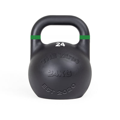 The SMAI The Yard - Competition Steel Kettlebell 24kg is black with a green stripe near the handle, "24" on top, and "THE YARD 24KG EST 2020" embossed on the front, ensuring consistent size and custom branding for reliable training.