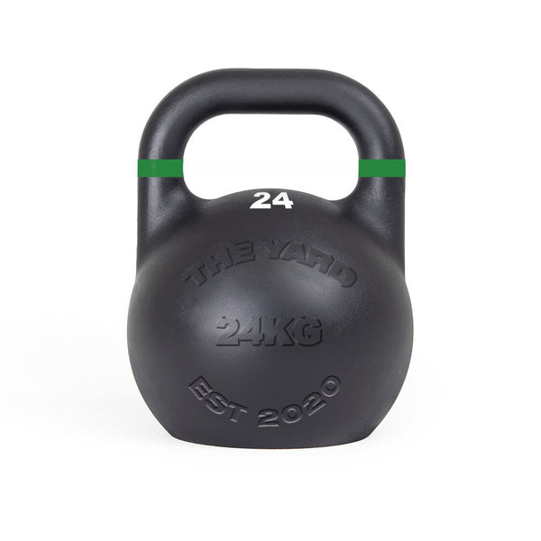 The SMAI The Yard - Competition Steel Kettlebell 24kg is black with a green stripe near the handle, "24" on top, and "THE YARD 24KG EST 2020" embossed on the front, ensuring consistent size and custom branding for reliable training.