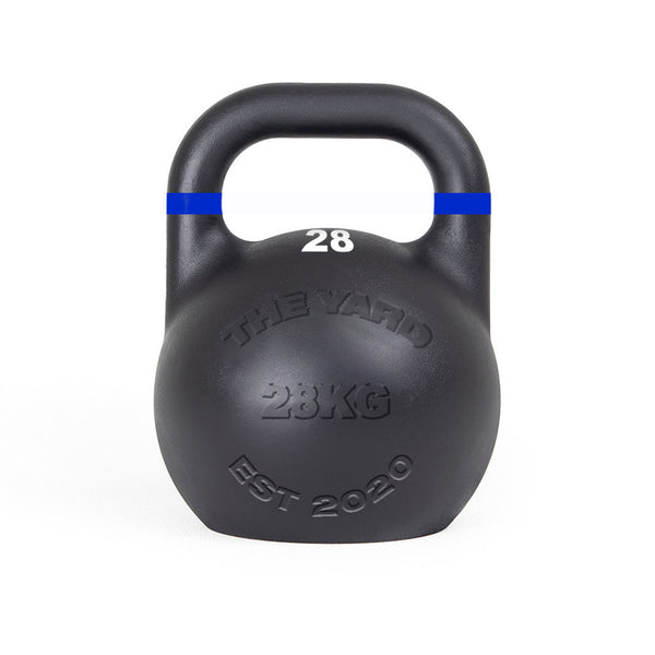 The SMAI The Yard - Competition Steel Kettlebell 28kg features a black finish, blue stripe near the handle, embossed "THE YARD 28KG EST 2020", and white "28" below the handle—ideal for kettlebell exercises in any serious gym.