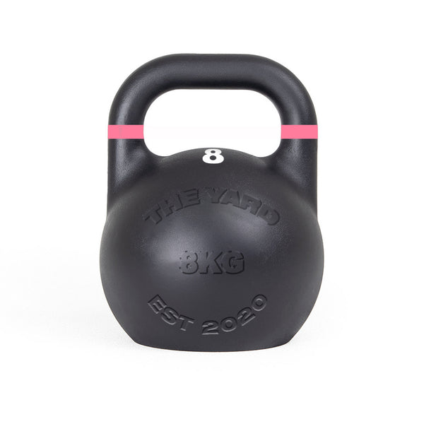 The Yard - Competition Steel Kettlebell 8kg by SMAI is a black, custom-branded kettlebell with a pink stripe near the handle and "THE YARD 8KG EST 2020" embossed on the front, designed to competition standards.