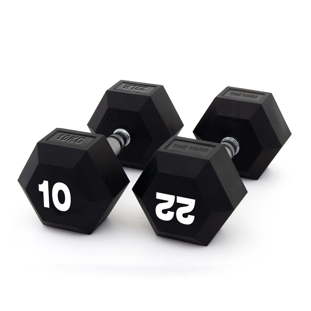 Two black SMAI "The Yard" Rubber Hex Dumbbells (10kg pair) with ergonomic grips and silver handles are shown on a white background, perfect for any commercial gym setup.