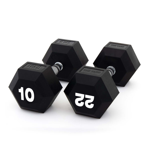 Two black SMAI "The Yard" Rubber Hex Dumbbells (10kg pair) with ergonomic grips and silver handles are shown on a white background, perfect for any commercial gym setup.