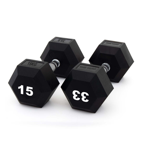 Three black SMAI Rubber Hex Dumbbells (The Yard - 15kg Pair) with ergonomic metal handles are arranged on a white background. The nearest dumbbells display large white numbers, "15" and "33.