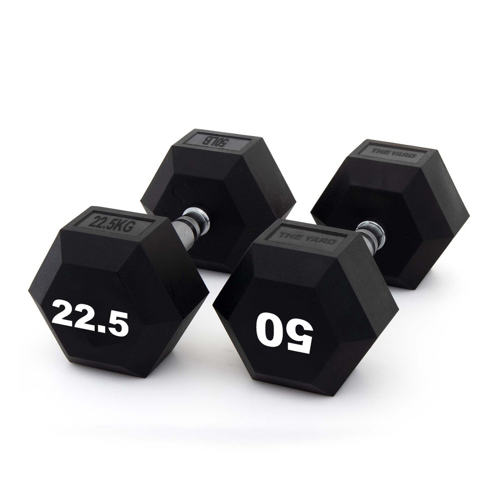 Three SMAI The Yard - Rubber Hex Dumbbells (22.5kg pairs) with ergonomic grips and silver handles are arranged on a white background, displaying large white "22.5" labels—ideal for commercial gym equipment setups.