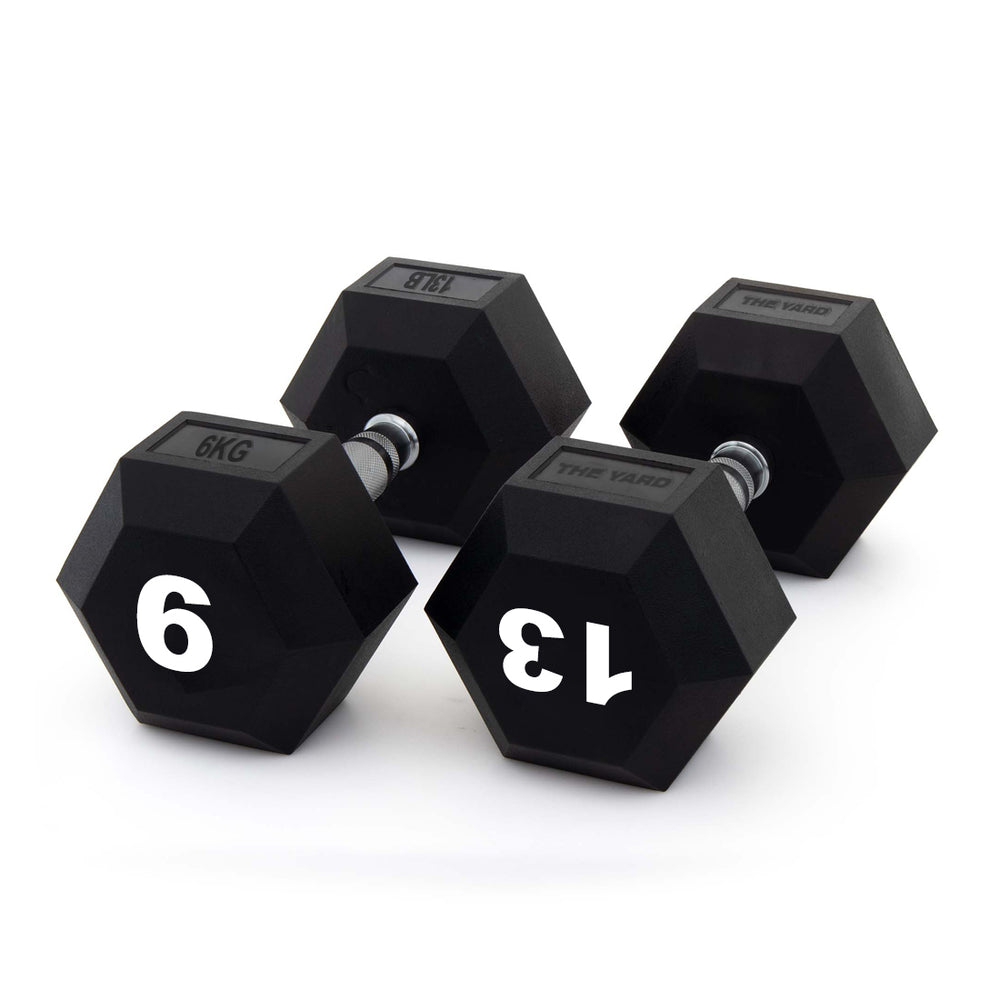 Three black hexagonal dumbbells from SMAI’s The Yard - Rubber Hex Dumbbell 6kg (Pair) range are displayed on a white background, each with a metallic textured handle and weights labeled 6 kg, 13 kg, and 18 kg.