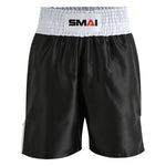 The SMAI Boxing Competition Shorts - Black feature shiny black and white satin polyester, a loose fit, and an extra-wide elastic waistband with the front-centered "SMAI" logo. Perfect for competition.