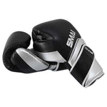 Two black and silver SMAI Silver Series Boxing Gloves with wrist support resting against each other.