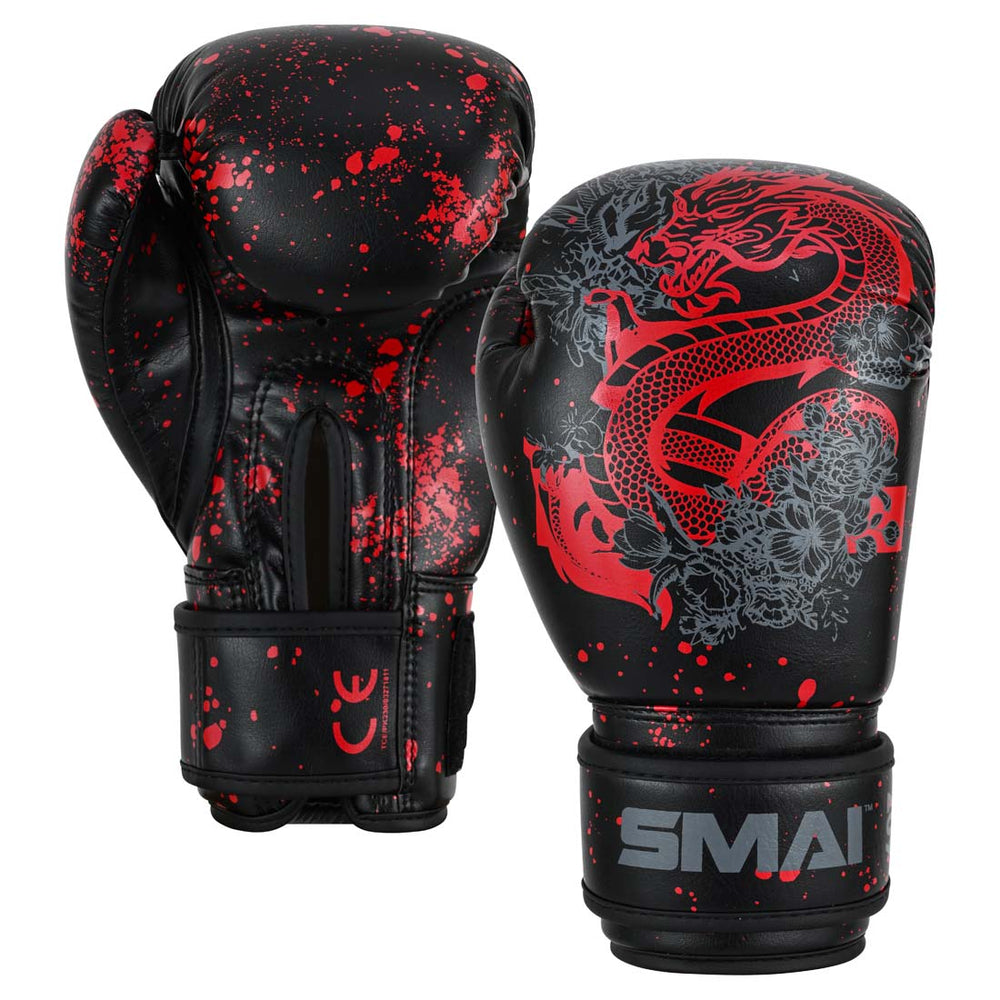 Two black SMAI Essentials Kids Boxing Glove - Red/Black Dragon gloves with red paint splatters, one featuring a large red dragon graphic.