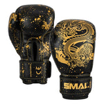 A pair of Essentials Kids Boxing Glove - Black/Gold Dragon, featuring black boxing gloves with gold dragon illustrations, gold stitching, and speckle patterns.