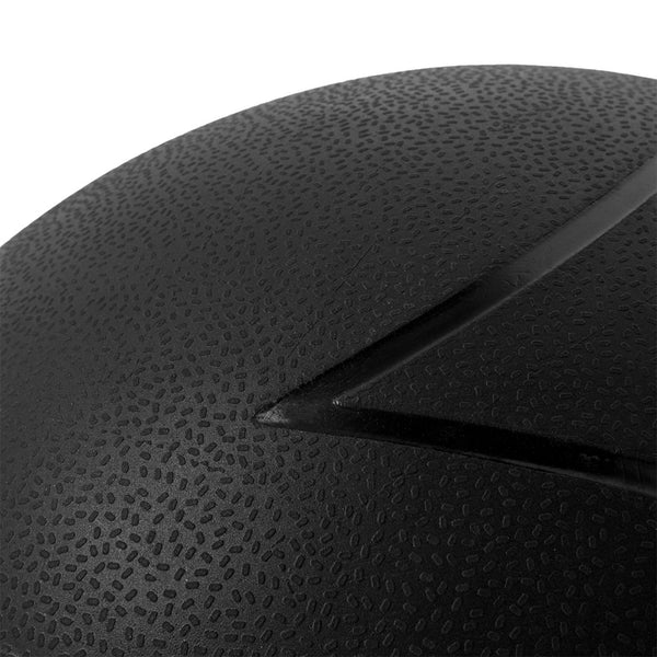 Close-up of a black textured surface on the SMAI The Yard - Slam Ball 40kg, highlighting its curved groove and small raised bumps on the durable, sand-filled rubber exterior.