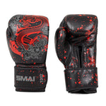 The SMAI Boxing Glove - Black Dragon Limited Edition features premium black cowhide leather, a red dragon and floral design on one glove, red paint splatter on both, and "SMAI" with "12 oz" printed on the wrist strap.