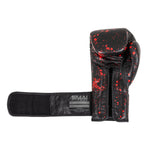The SMAI Boxing Glove - Black Dragon Limited Edition features black cowhide leather with a red paint splatter, injection moulded padding, an open wrist strap, and a visible label. Shown palm-side up on a white background.