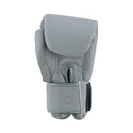 The SMAI Elite85 Boxing Glove - Charcoal is a single gray glove crafted from durable cowhide leather with visible stitching and a hook-and-loop strap, displayed upright against a white background.