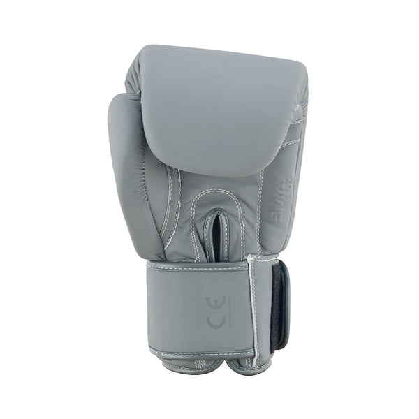 The SMAI Elite85 Boxing Glove - Charcoal is a single gray glove crafted from durable cowhide leather with visible stitching and a hook-and-loop strap, displayed upright against a white background.