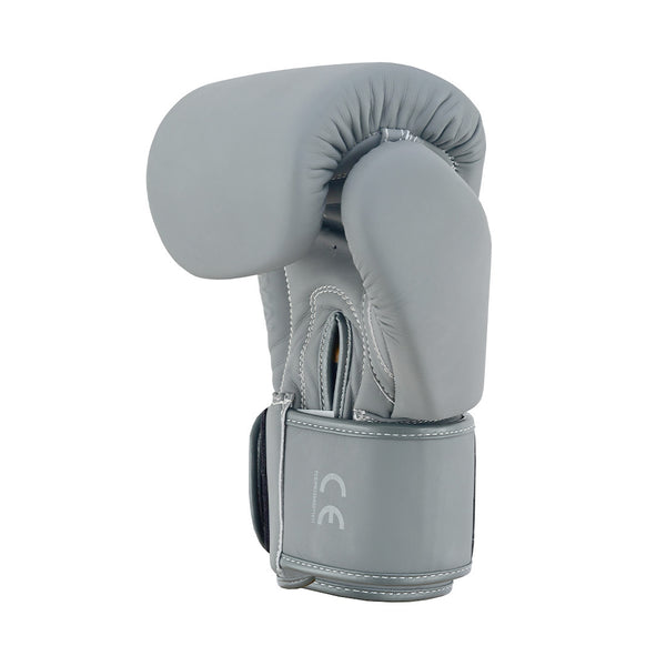 The SMAI Elite85 Boxing Glove in Charcoal, crafted from durable cowhide leather, stands upright on a white background, highlighting its padded front, wrist strap with white stitching, and "CE" markings.