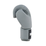 The SMAI Elite85 Boxing Glove - Charcoal is made from premium cowhide leather with a black and white strap, displayed upright with the palm facing left against a white background.