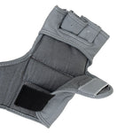 A close-up of a gray wrist support brace with adjustable straps, ideal for stability during intense workouts—perfectly paired with SMAI Elite85 MMA Gloves - Charcoal for added protection.