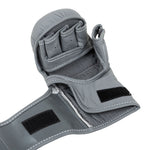 A close-up of the SMAI Elite85 MMA Hybrid Sparring Glove in charcoal, showcasing an open palm design, finger slots, Velcro straps for secure fit, and detailed white stitching—ideal for MMA or sparring.