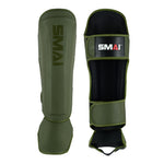 Two olive green SMAI Elite85 Muay Thai shin guards are shown: one displays the logo, while the other reveals adjustable straps and interior padding, emphasizing their lightweight design.