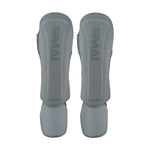 The SMAI Elite85 Muay Thai Shin Guards in charcoal are lightweight with padded protection for shins and feet, making them ideal for Muay Thai training.
