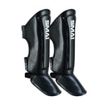 The Essentials Muay Thai Shin Guards Kids - Black by SMAI, shown upright on a white background, are ideal protective shin guards for kids’ martial arts and sports gear.