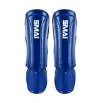 A pair of SMAI Essentials Muay Thai Shin Guards for kids in blue, featuring durable protection and white "SMAI" branding on the shin, shown side by side against a white background.