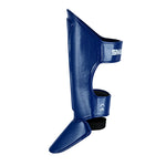 SMAI Essentials Muay Thai Shin Guards Kids - Blue offer durable synthetic protection with ankle and foot coverage, adjustable straps for a secure fit, and feature the SMAI logo on the upper strap. Ideal for young martial artists.