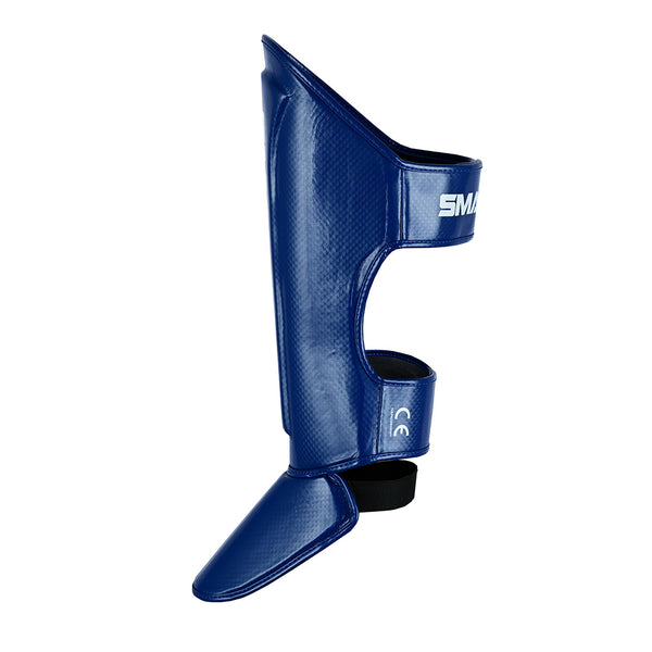 SMAI Essentials Muay Thai Shin Guards Kids - Blue offer durable synthetic protection with ankle and foot coverage, adjustable straps for a secure fit, and feature the SMAI logo on the upper strap. Ideal for young martial artists.