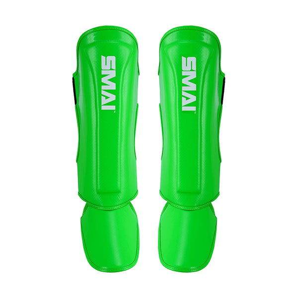Essentials Muay Thai Shin Guards Kids in bright green by SMAI, shown on a white background—ideal protective sports gear for young athletes.