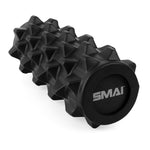 The Deep Tissue Therapy Pack, featuring a black spiked foam roller with the SMAI logo on the end cap, is ideal for trigger therapy. Designed for deep tissue massage and muscle recovery, this foam roller has a textured surface and is artfully showcased diagonally against a white background.
