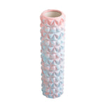The SMAI Foam Roller - Trigger Point is a pastel pink and blue, textured foam roller ideal for muscle recovery, massage, Pilates, and physical therapy routines.