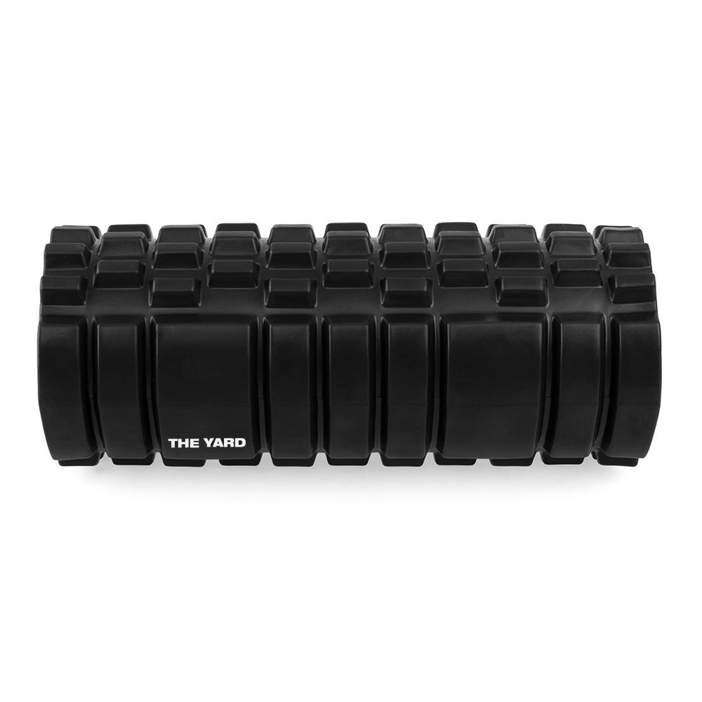 The SMAI The Yard - Foam Roller - Trigger Point 3D is a black, textured foam roller with rectangular ridges and "THE YARD" printed on the side, designed for muscle massage and exercise recovery.
